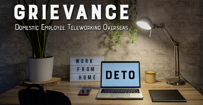 Grievance Domestic Employee Teleworking Overseas DETO, image shows a home office with plant, cell phone, lamp and laptop on the desk